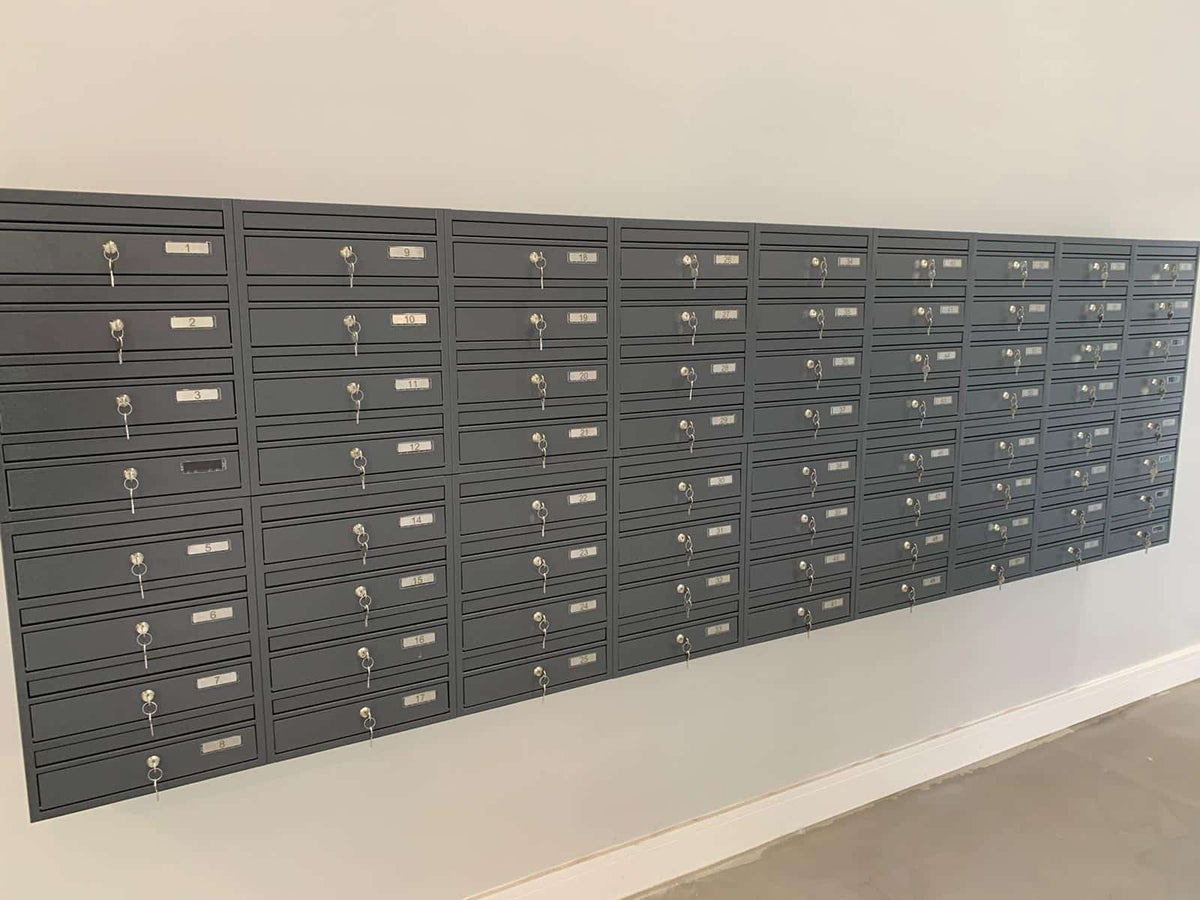 communal post boxes on the wall in dark grey colour