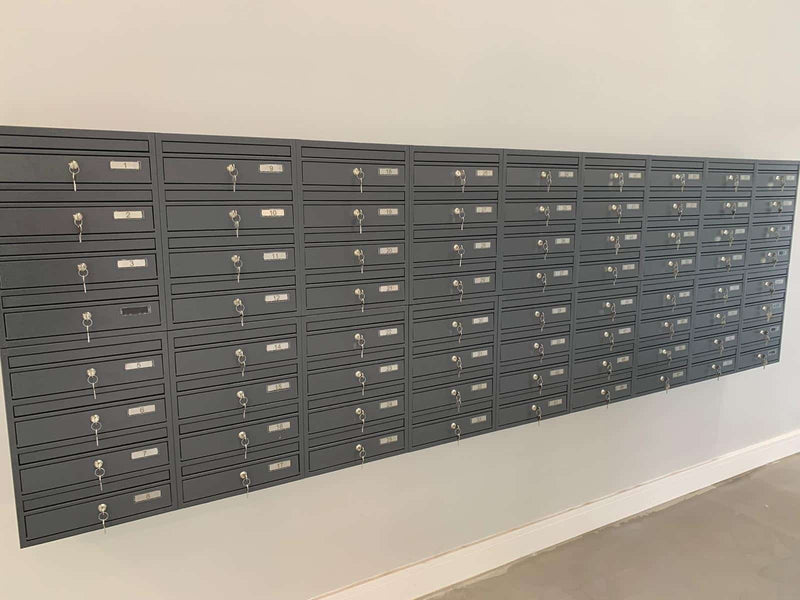 communal post boxes on the wall in dark grey colour